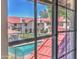 View of the community pool and complex buildings from inside a window, showcasing the property's amenities at 6262 E Brown Rd # 65, Mesa, AZ 85205