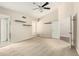 A large bedroom with neutral carpet, a ceiling fan and bathroom access at 6313 E Aire Libre Ln, Scottsdale, AZ 85254