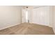 A bedroom with neutral walls, carpet, and an open door at 6313 E Aire Libre Ln, Scottsdale, AZ 85254