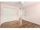 Bedroom features wood floors and a closet with paneled doors at 6313 E Aire Libre Ln, Scottsdale, AZ 85254
