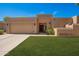 Charming single-story home with a well-manicured lawn and an attached two-car garage at 6313 E Aire Libre Ln, Scottsdale, AZ 85254