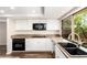 A full view of the kitchen featuring white cabinets, granite counters and stainless steel appliances at 6313 E Aire Libre Ln, Scottsdale, AZ 85254