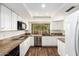 Bright kitchen with stainless steel appliances, granite counters, and white cabinetry at 6313 E Aire Libre Ln, Scottsdale, AZ 85254