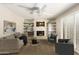 Cozy living room featuring a fireplace, built-in shelving, and plantation shutters for natural light at 6313 E Aire Libre Ln, Scottsdale, AZ 85254