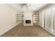 Living room with neutral carpet, fireplace, and shelving at 6313 E Aire Libre Ln, Scottsdale, AZ 85254