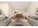 Bright living room with hardwood floors, neutral paint, soaring ceilings and ample seating for entertaining at 6313 E Aire Libre Ln, Scottsdale, AZ 85254