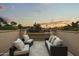 Inviting balcony showcases comfortable seating and serene views of the surrounding landscape at sunset at 6852 E Fanfol Dr, Paradise Valley, AZ 85253