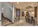 Charming bar area with seating, stone accents, and decorative lighting near the staircase at 6852 E Fanfol Dr, Paradise Valley, AZ 85253