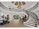 Grand foyer with a spiral staircase, chandelier, and open floor plan at 6852 E Fanfol Dr, Paradise Valley, AZ 85253