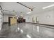 Spacious three-car garage featuring a sealed concrete floor, ample storage, and dual access doors at 6852 E Fanfol Dr, Paradise Valley, AZ 85253