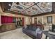 Elegant living room with custom card ceiling, bar, billiards, and plush seating at 6852 E Fanfol Dr, Paradise Valley, AZ 85253