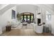Bright living room features high ceilings, a stone fireplace, and large windows that flood the space with natural light at 6852 E Fanfol Dr, Paradise Valley, AZ 85253
