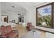 Luxurious bedroom with a seating area, large windows, and elegant decor at 6852 E Fanfol Dr, Paradise Valley, AZ 85253