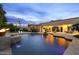 Stunning pool area with lush landscaping, a tranquil fountain, and a seamless flow to the home's patio at 6852 E Fanfol Dr, Paradise Valley, AZ 85253
