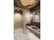 Chic powder room features a unique stone sink, decorative mirror, and textured walls for a luxurious feel at 6852 E Fanfol Dr, Paradise Valley, AZ 85253