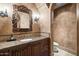 Elegant powder room featuring ornate mirror, granite countertop, and custom vanity at 6852 E Fanfol Dr, Paradise Valley, AZ 85253