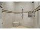 Walk-in shower featuring custom tile work, a built-in bench, and a rainfall showerhead at 6852 E Fanfol Dr, Paradise Valley, AZ 85253