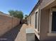 A spacious backyard with gravel landscaping, block fence and view of surrounding trees at 703 E Taylor Trl, San Tan Valley, AZ 85143