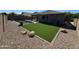 Well-maintained backyard with artificial turf, rock landscaping, and a sparkling pool with surrounding patio at 703 E Taylor Trl, San Tan Valley, AZ 85143