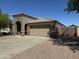 Single story home with tan stucco, tile roof, three car garage, and low maintenance landscaping at 703 E Taylor Trl, San Tan Valley, AZ 85143