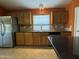 Well-equipped kitchen featuring modern stainless steel appliances, granite countertops, and ample cabinet space at 703 E Taylor Trl, San Tan Valley, AZ 85143