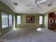 Cozy living room with plush carpet, a ceiling fan, and natural light creating a warm and inviting atmosphere at 703 E Taylor Trl, San Tan Valley, AZ 85143