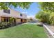 Spacious backyard with a well-maintained lawn, inviting pool, and covered patio at 7326 W Pershing Ave, Peoria, AZ 85381