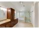Bright bathroom with a tiled floor, a glass-enclosed shower, and double sinks with granite countertops at 7326 W Pershing Ave, Peoria, AZ 85381