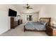 Bedroom features carpet, fan, and wood furniture, creating a comfortable and relaxing retreat at 7326 W Pershing Ave, Peoria, AZ 85381