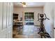 Versatile bonus room with workspace, exercise equipment, and sliding glass doors to the outdoor pool at 7326 W Pershing Ave, Peoria, AZ 85381