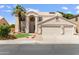 Charming two-story home featuring a three car garage, desert landscaping and a palm tree at 7326 W Pershing Ave, Peoria, AZ 85381