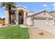 Charming two-story home featuring a three car garage, desert landscaping and green grass at 7326 W Pershing Ave, Peoria, AZ 85381