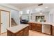Bright kitchen with breakfast bar, stainless steel appliances, and an open layout to the living room and stairway at 7326 W Pershing Ave, Peoria, AZ 85381