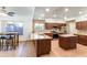 Modern kitchen with stainless steel appliances, granite countertops, and a center island with sink at 7326 W Pershing Ave, Peoria, AZ 85381