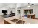 Spacious kitchen with stainless steel sink, breakfast bar, and an open concept design leading to the dining and living areas at 7326 W Pershing Ave, Peoria, AZ 85381