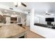 Expansive living area showcases an open layout with kitchen and living room, ideal for modern living and entertaining at 7326 W Pershing Ave, Peoria, AZ 85381