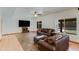 Comfortable living room features a large TV, plush seating, and abundant natural light for a relaxed atmosphere at 7326 W Pershing Ave, Peoria, AZ 85381