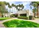 Inviting exterior showing lush lawn, mature landscaping and building with large windows at 7350 N Via Paseo Del Sur -- # Q105, Scottsdale, AZ 85258