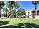 Expansive grassy area surrounded by tall palm trees with well-maintained landscaping in a welcoming community at 7350 N Via Paseo Del Sur -- # Q105, Scottsdale, AZ 85258