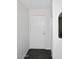 Clean hallway with white door and dark herringbone floors, showcasing modern, minimalist design elements at 7350 N Via Paseo Del Sur -- # Q105, Scottsdale, AZ 85258