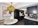 Stylish kitchen nook featuring marble table, unique lighting, and modern black cabinets for a contemporary touch at 7350 N Via Paseo Del Sur -- # Q105, Scottsdale, AZ 85258