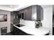 Kitchen features modern countertops, dark cabinets, and stainless steel appliances at 7350 N Via Paseo Del Sur -- # Q105, Scottsdale, AZ 85258