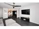 Open concept living room with dark herringbone floors, modern furnishings, and seamless flow to kitchen at 7350 N Via Paseo Del Sur -- # Q105, Scottsdale, AZ 85258