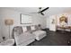 Stylish living room featuring dark floors, neutral sofa, modern lighting, and inviting, open layout for comfortable living at 7350 N Via Paseo Del Sur -- # Q105, Scottsdale, AZ 85258
