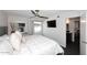 Bright main bedroom featuring a ceiling fan, large window and a comfortable-looking bed with attached bathroom at 7350 N Via Paseo Del Sur -- # Q105, Scottsdale, AZ 85258