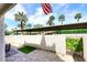 A cozy patio features paver flooring, a privacy wall, and a view of palm trees and a covered parking area at 7350 N Via Paseo Del Sur -- # Q105, Scottsdale, AZ 85258