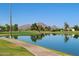 A serene pond view with lush golf course and mountains reflecting the beautiful clear blue sky at 7350 N Via Paseo Del Sur -- # Q105, Scottsdale, AZ 85258