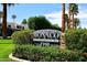 Attractive community entrance sign with manicured landscaping and vibrant red flowers, inviting residents and guests at 7350 N Via Paseo Del Sur -- # Q105, Scottsdale, AZ 85258