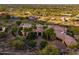 Aerial shot of a luxury home with lush landscaping and a circular driveway with palm trees at 7801 N Saguaro Dr, Paradise Valley, AZ 85253