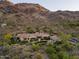 Panoramic aerial view of a luxurious estate with a large pool and lush landscaping against a mountain backdrop at 7801 N Saguaro Dr, Paradise Valley, AZ 85253